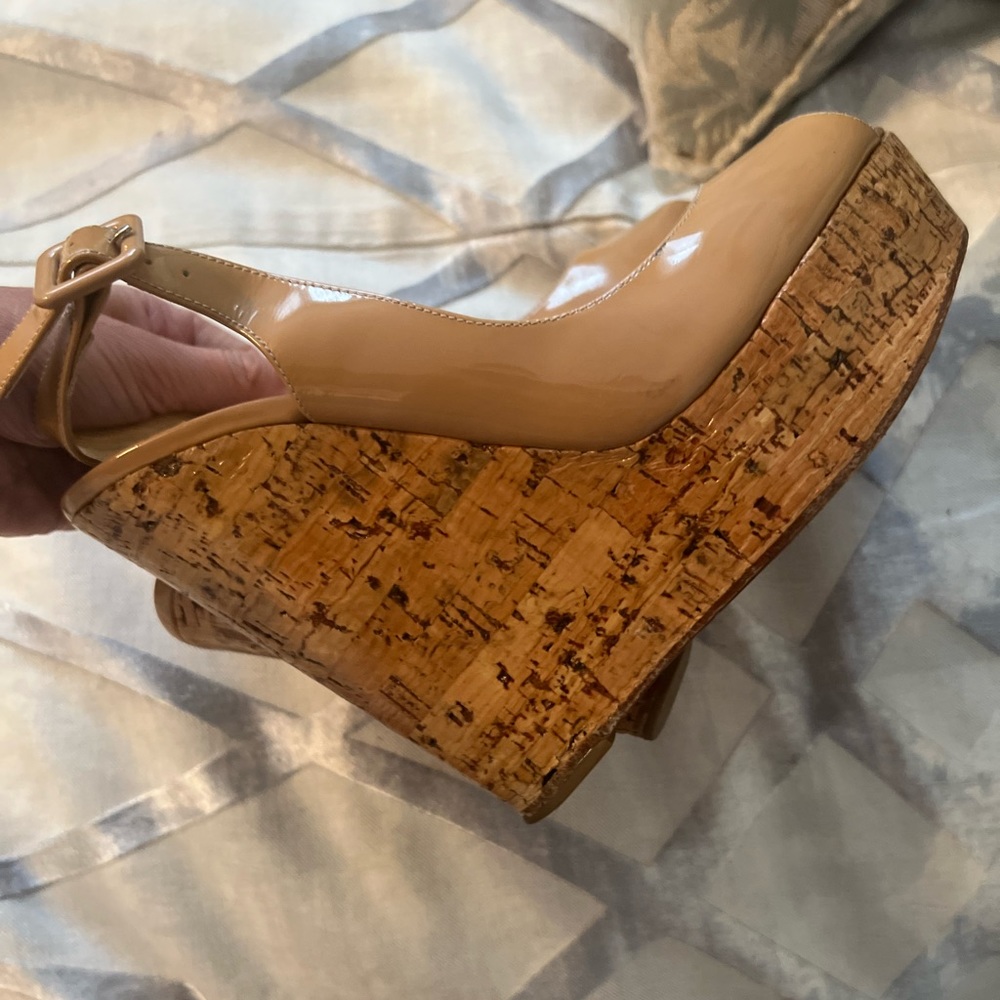 Used Christian Louboutin patent leather sling back wedge in color nude
